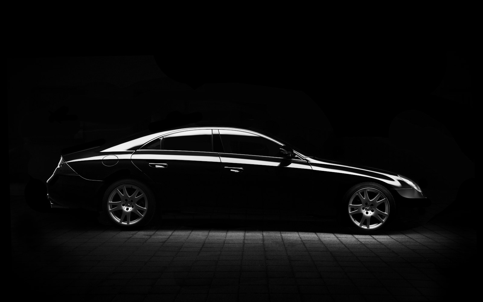 A premium sedan in dramatic studio light